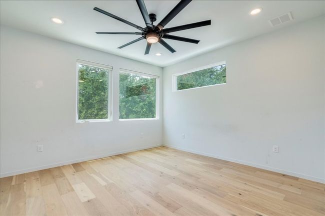 Empty room featuring healthy amount of natural light, a ceiling fan, light wood-type flooring, and recessed lighting | Image 13