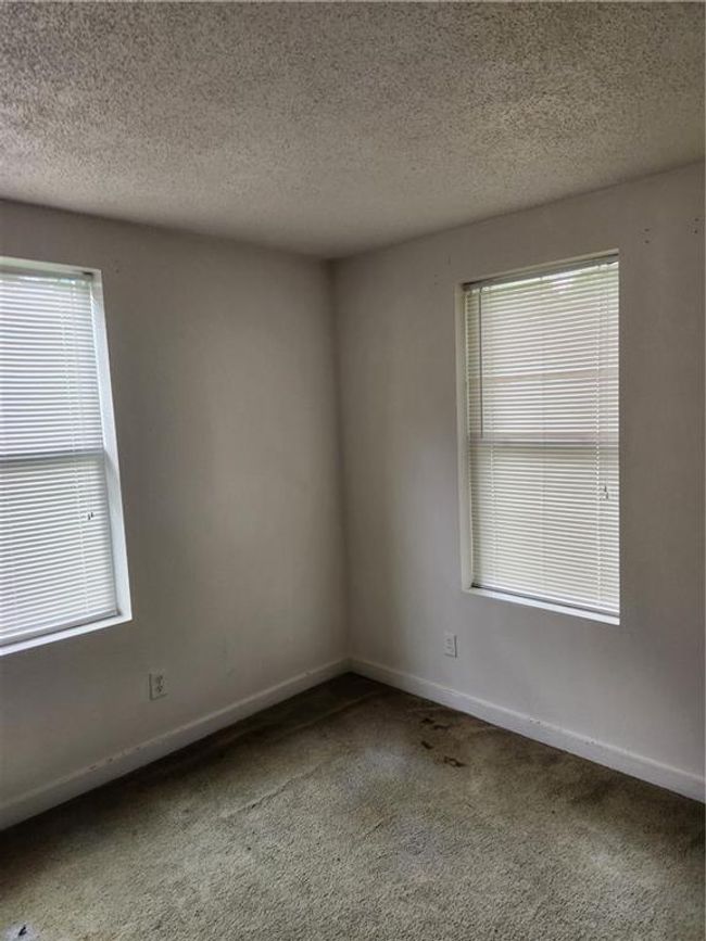 Carpeted spare room featuring a textured ceiling | Image 12
