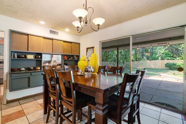Dining room with a chandelier, light tile patterned floors, a textured ceiling, recessed lighting, and crown molding | Image 10
