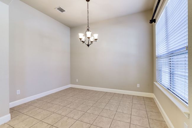 Empty room featuring a chandelier and light tile patterned floors | Image 8