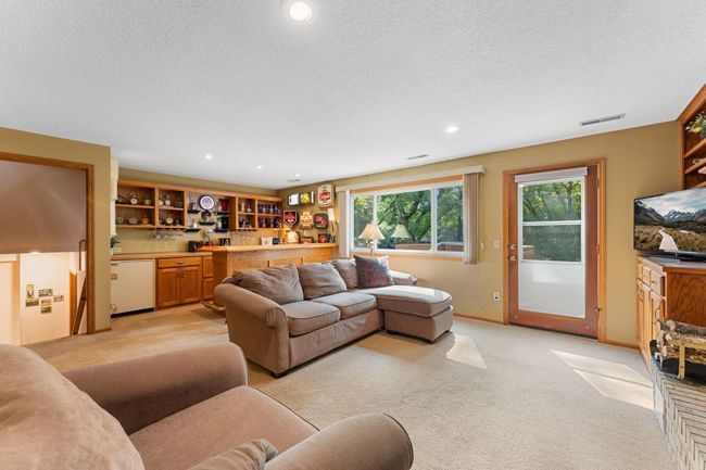 Don't miss the custom built in bar with wine fridge and beverage fridge. | Image 25