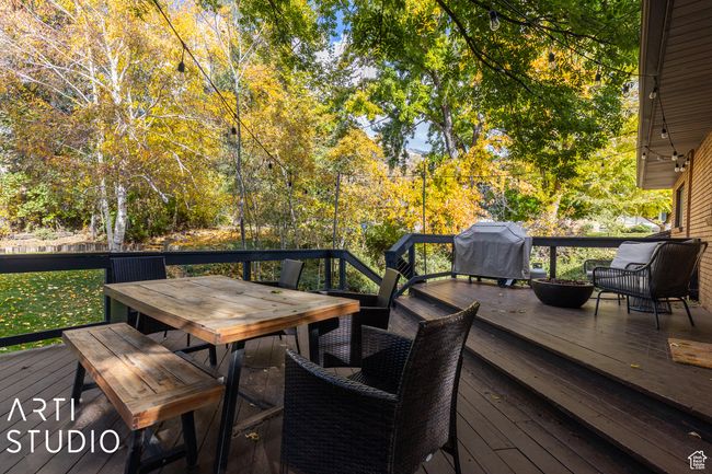 Wooden deck with outdoor dining area and a grill | Image 54