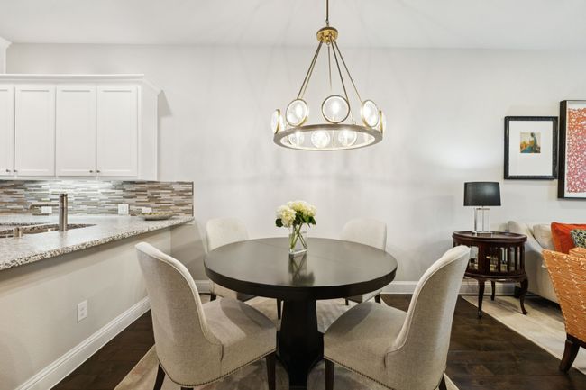 Dining room with dark wood-style flooring and a chandelier | Image 10