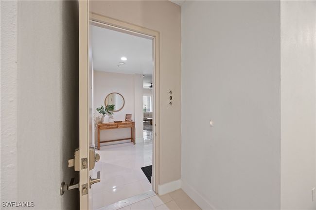 Corridor with light tile patterned flooring and baseboards | Image 24