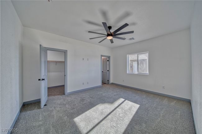 Another view of the primary bedroom, showcasing the spacious walk-in closet and plenty of natural light for a bright, inviting atmosphere. | Image 13