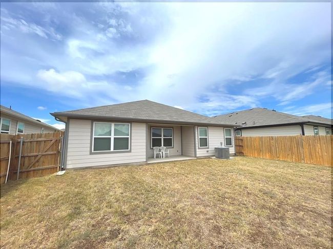 Back of house with a patio, cooling unit, and a shingled roof | Image 20
