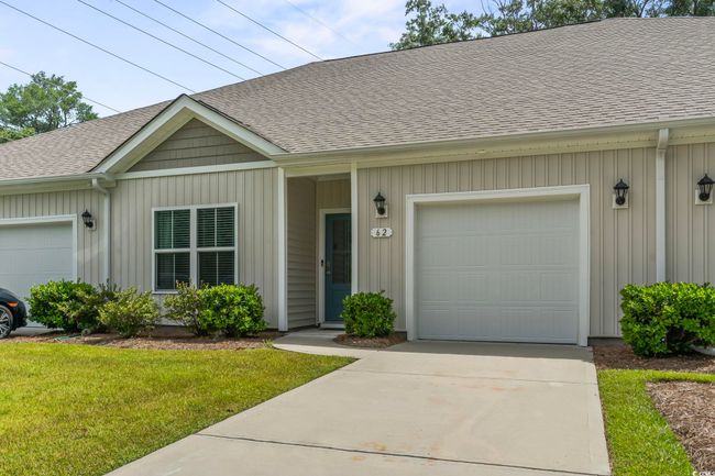View of front of home featuring roof with shingles, an attached garage, and a front lawn | Image 14