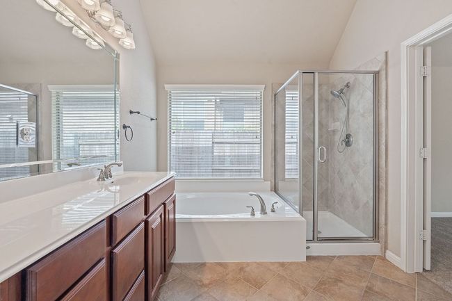 Full bath with double vanity, a bath, plenty of natural light, and a shower stall | Image 15