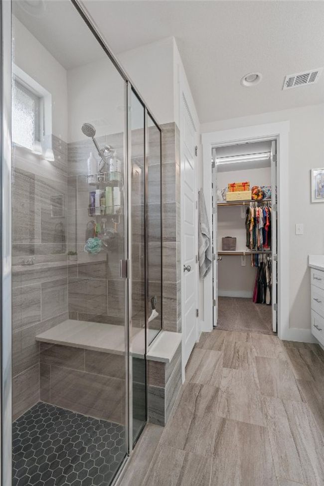 Bathroom with a stall shower, vanity, a spacious closet, and recessed lighting | Image 18