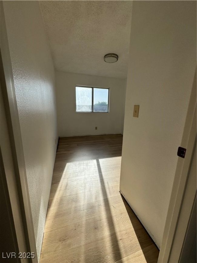 Corridor featuring wood finished floors and a textured ceiling | Image 14