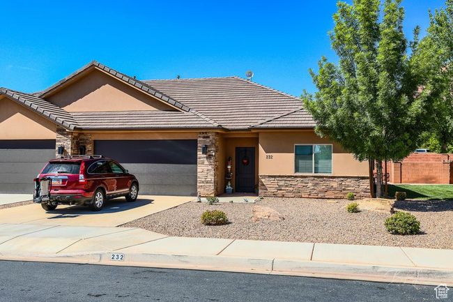 Ranch-style home featuring an attached garage, stone siding, concrete driveway, and stucco siding | Image 8