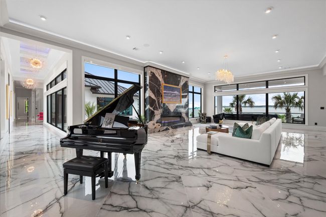 Living room featuring crown molding, recessed lighting, a chandelier, and marble finish floor | Image 5