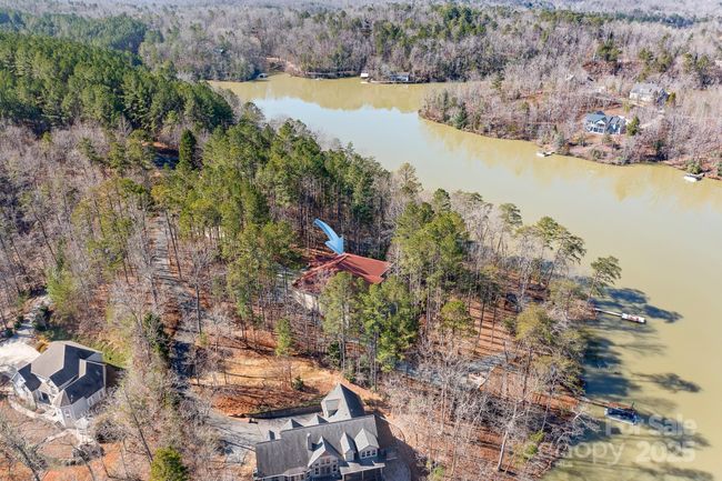 Prime lakefront location with sweeping views of Lake Adger and Lake Access at your private shoreline with floating dock, Kayak Storage, Firepit and more | Image 43