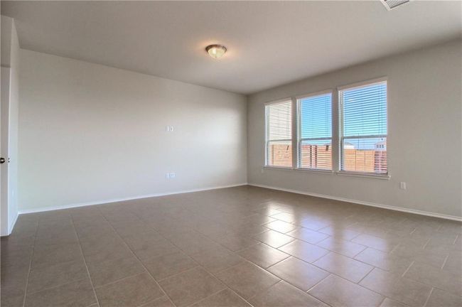 Tiled empty room featuring baseboards | Image 14