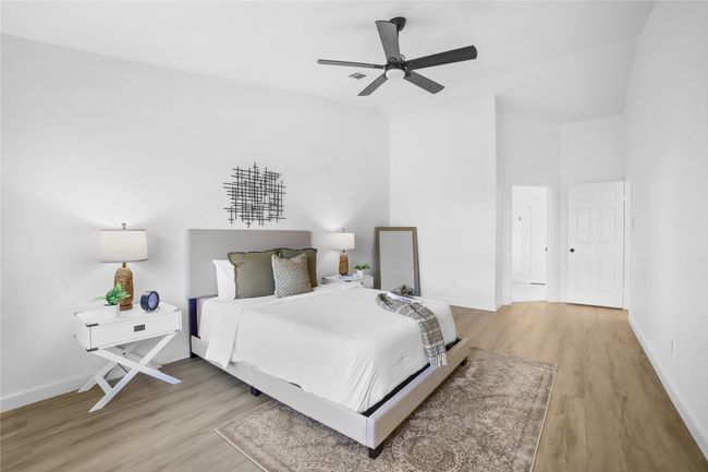 Bedroom featuring light wood-style flooring, vaulted ceiling, and a ceiling fan | Image 12