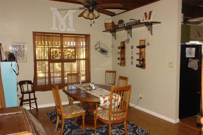 Dining area featuring ceiling fan and dark hardwood / wood-style floors | Image 6