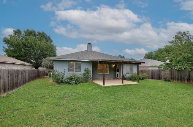 Rear view of property with a patio area and a chimney | Image 25