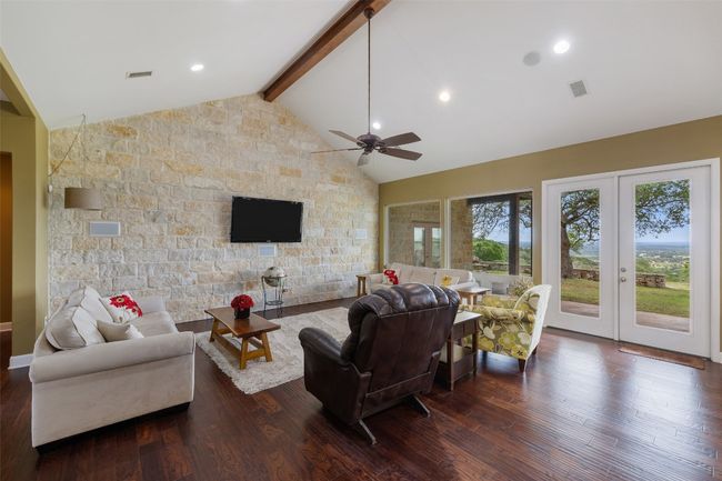 Living area with visible vents, ceiling fan, and dark wood-style floors | Image 20