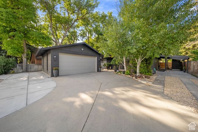 View of front of home featuring concrete driveway, brick siding, and an attached garage | Image 30