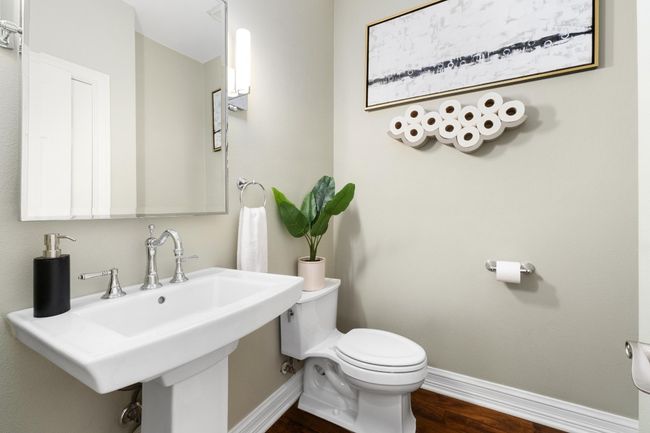 Half bath with baseboards and wood finished floors | Image 21