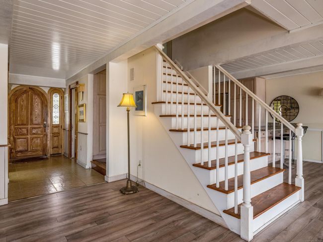 Entry with custom door and wide, beautiful stiarcase. | Image 9