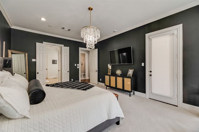 Bedroom with a chandelier, light carpet, and ornamental molding | Image 8