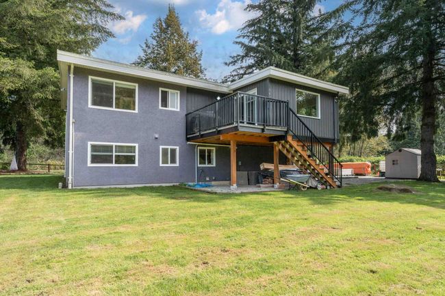 Back of property with a deck, stairs, a yard, and a patio area | Image 24