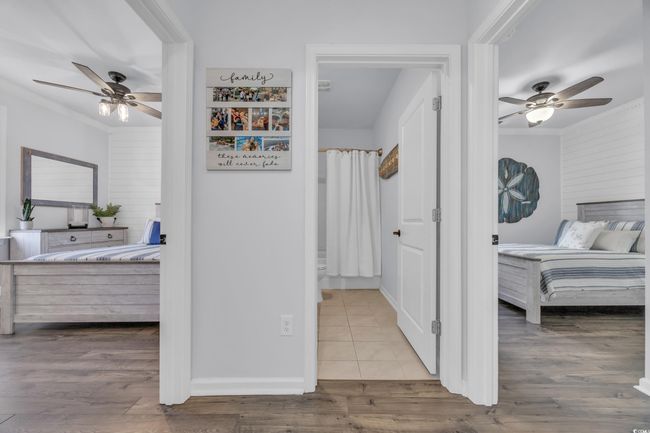 Bedroom featuring a ceiling fan, wood finished floors, baseboards, and crown molding | Image 21