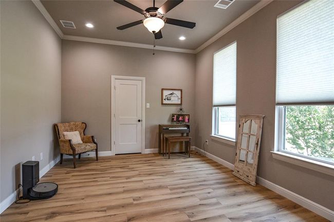 Sitting room with ceiling fan, light hardwood / wood-style flooring, and crown molding | Image 29