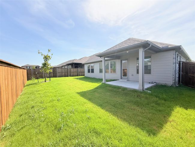 Back of property with a fenced backyard, a patio area, and roof with shingles | Image 31