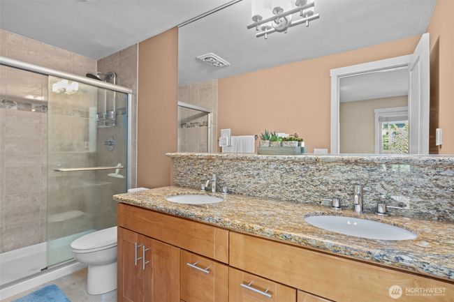 I love the glass shower doors for easy cleaning and the shower tiles that go all the way to the ceiling! Also, the higher countertop and the dual vanity is almost as nice as the over-sized mirror - Wow! | Image 21