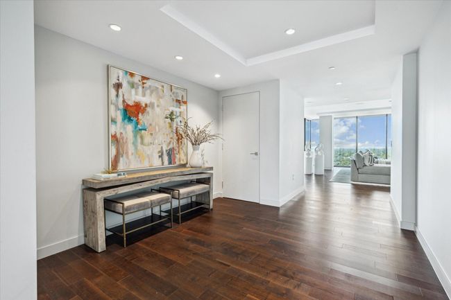 The foyer is a welcoming space that flows to the living room to the right and the study to the left. All of the spaces are light, bright and beautiful. The abundance of natural light in the home is unmatched. | Image 8