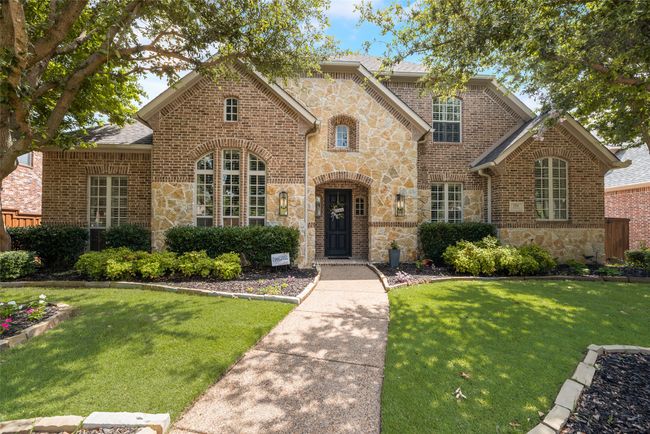 View of front facade with stone siding, a front lawn, and brick siding | Image 38