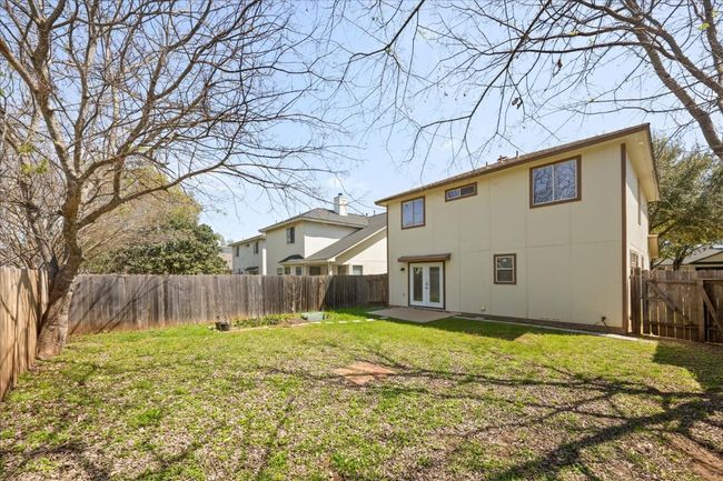 Rear view of house featuring a patio, a yard, a fenced backyard, and french doors | Image 31
