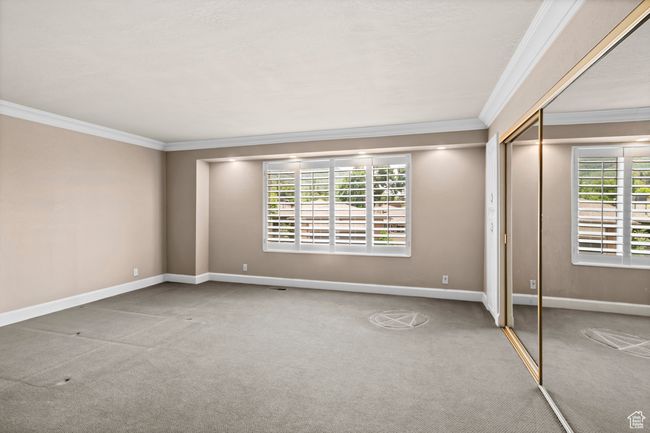 Spare room featuring crown molding and carpet floors | Image 20