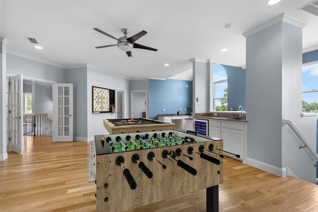 Featuring beautiful wood flooring, built-in cabinets, and large windows that fill the space with natural light! | Image 22