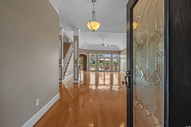 Entrance foyer with stairway, wood finished floors, and a ceiling fan | Image 6