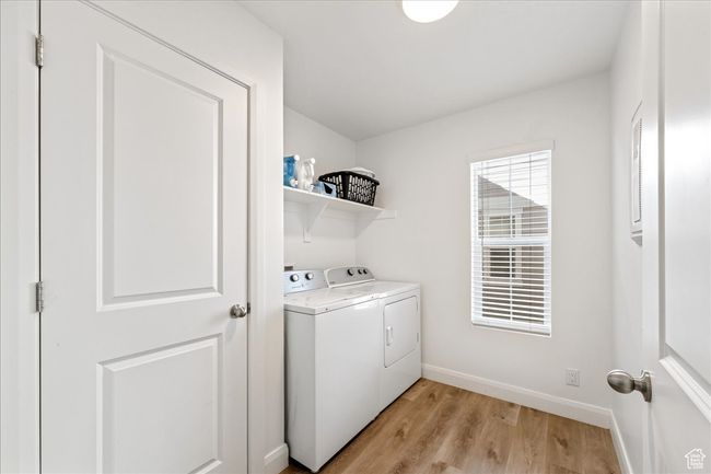 Laundry room with independent washer and dryer and light wood-type flooring | Image 28