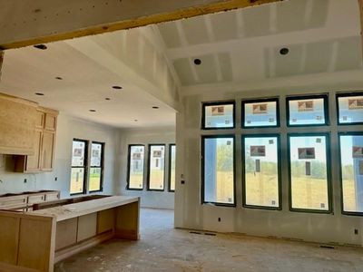 Kitchen featuring a breakfast bar, custom exhaust hood, and a center island | Image 3