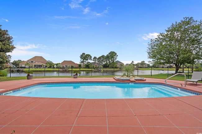 View of swimming pool with a residential view, a water view, and a patio area | Image 16