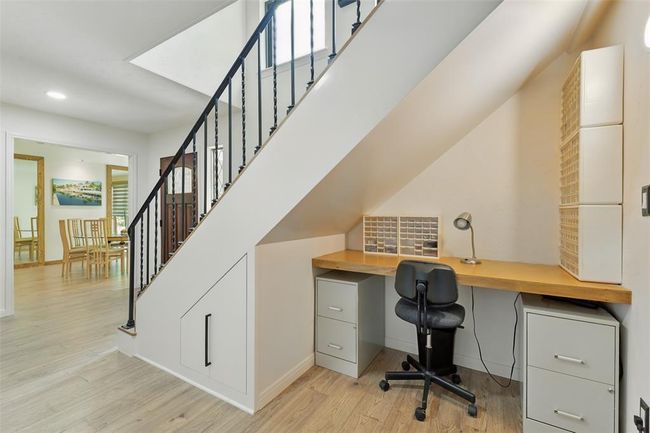 There is a built-in desk tucked underneath the stairs. | Image 23