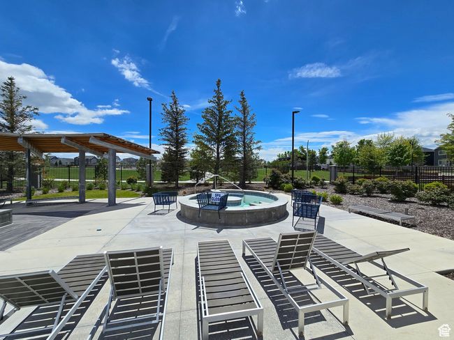 View of swimming pool with a patio area and an in-ground hot tub | Image 23