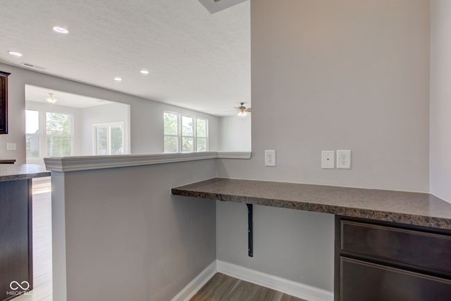 kitchen featuring dark countertops, dark wood-style floors, recessed lighting, a peninsula, and dark brown cabinetry | Image 28