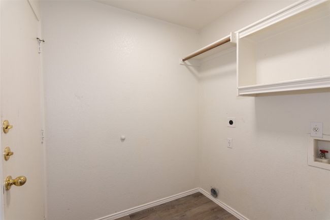 Laundry room with built-in shelf and hanging rod | Image 25
