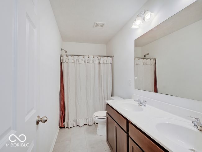 Hall bath featuring ceramic tile floor, & double sink vanity | Image 19