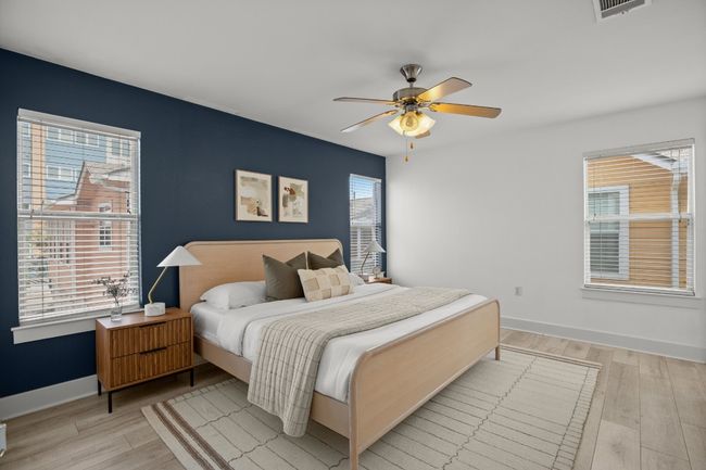 Bedroom with light wood-style flooring, baseboards, and a ceiling fan | Image 10