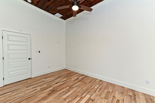 Second bedroom with wooden ceiling, a ceiling fan, light wood-type flooring, and vaulted ceiling | Image 21