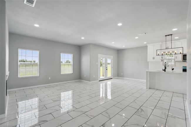 Unfurnished living room featuring recessed lighting, plenty of natural light, and visible vents | Image 10