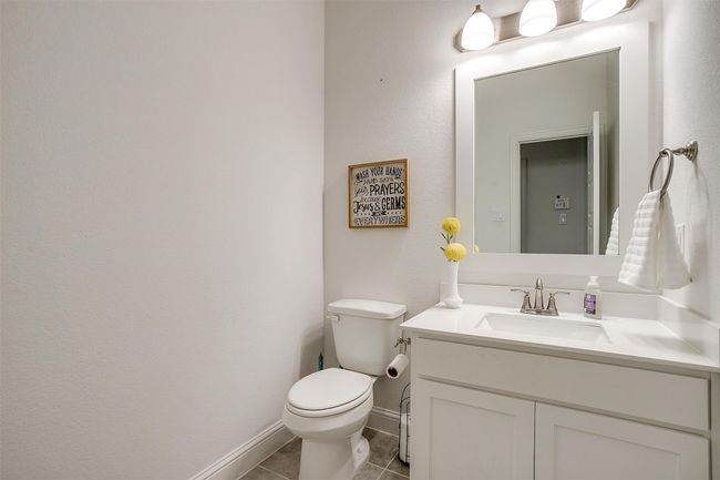 Bathroom featuring toilet, vanity, tile patterned floors, and baseboards | Image 34