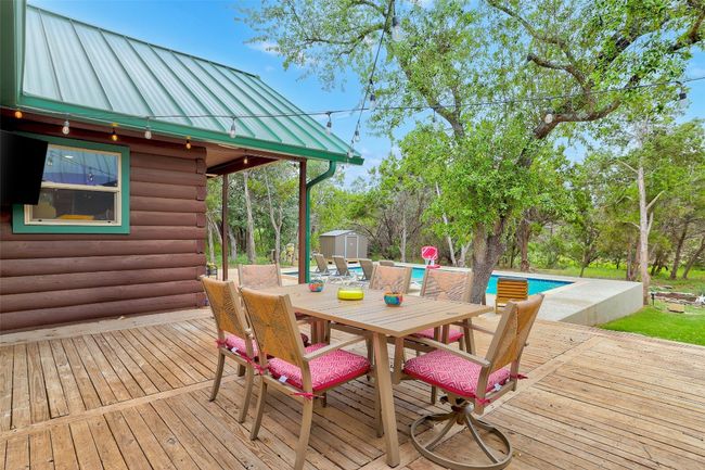 Deck with outdoor dining space overlooking the pool | Image 33